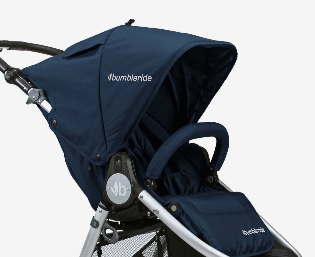 Collapsable baby stroller with a navy blue canvas, black plastic handle grid and metal alloy exterior.